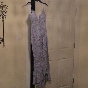 Lavender long dress with ruffles down the side and slit.